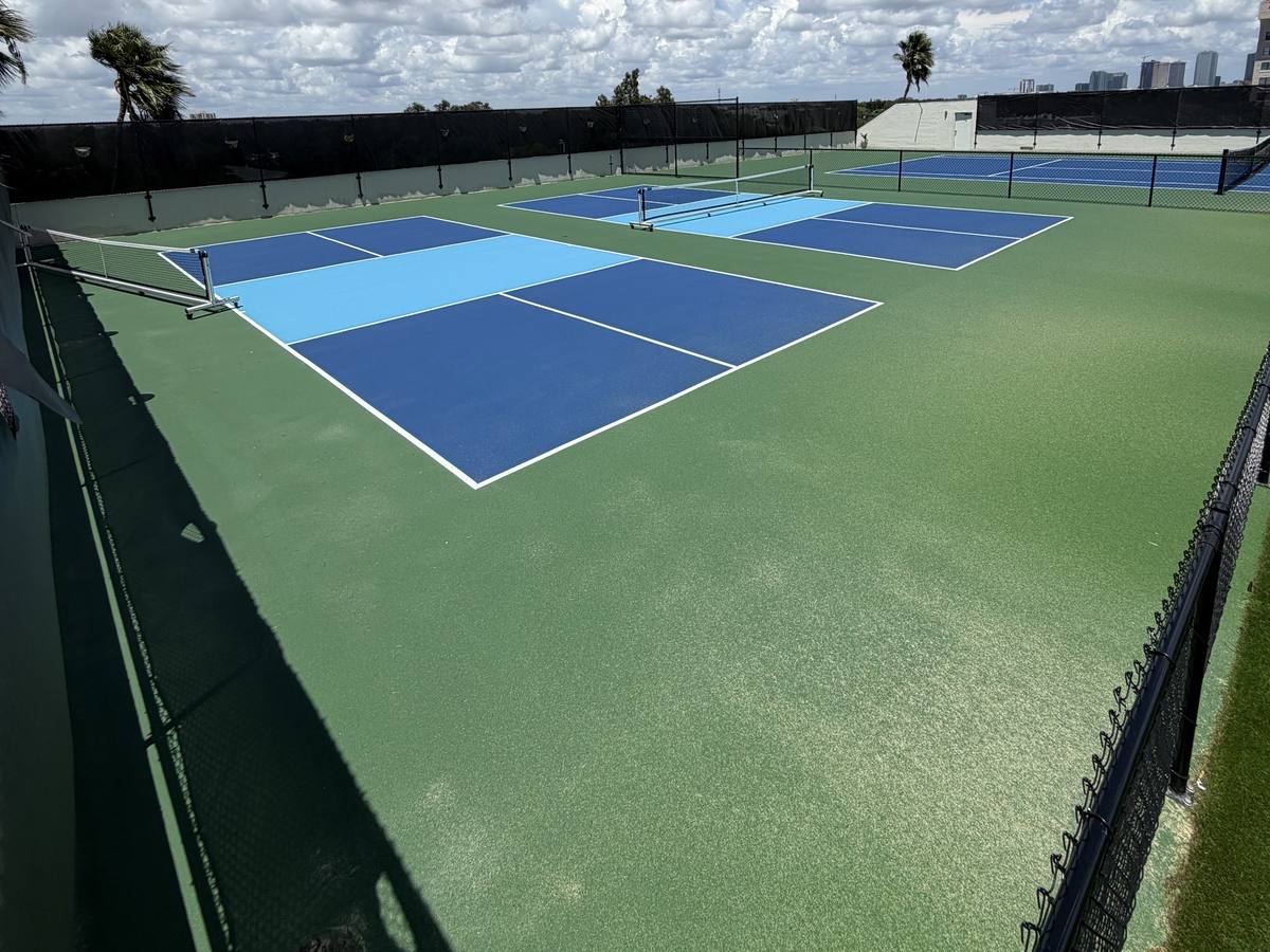 Close view of rooftop pickleball courts in light and dark blue with white lines