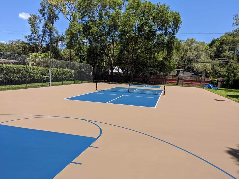 Blue and tan pickleball court with a basketball key, freshly striped